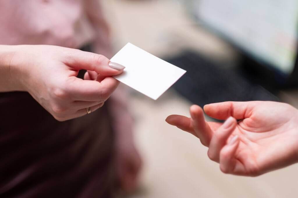 Girl giving a man a white card
